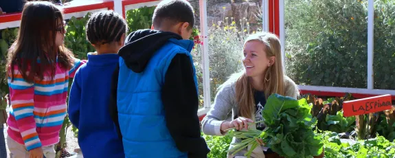 Student intern working in school garden